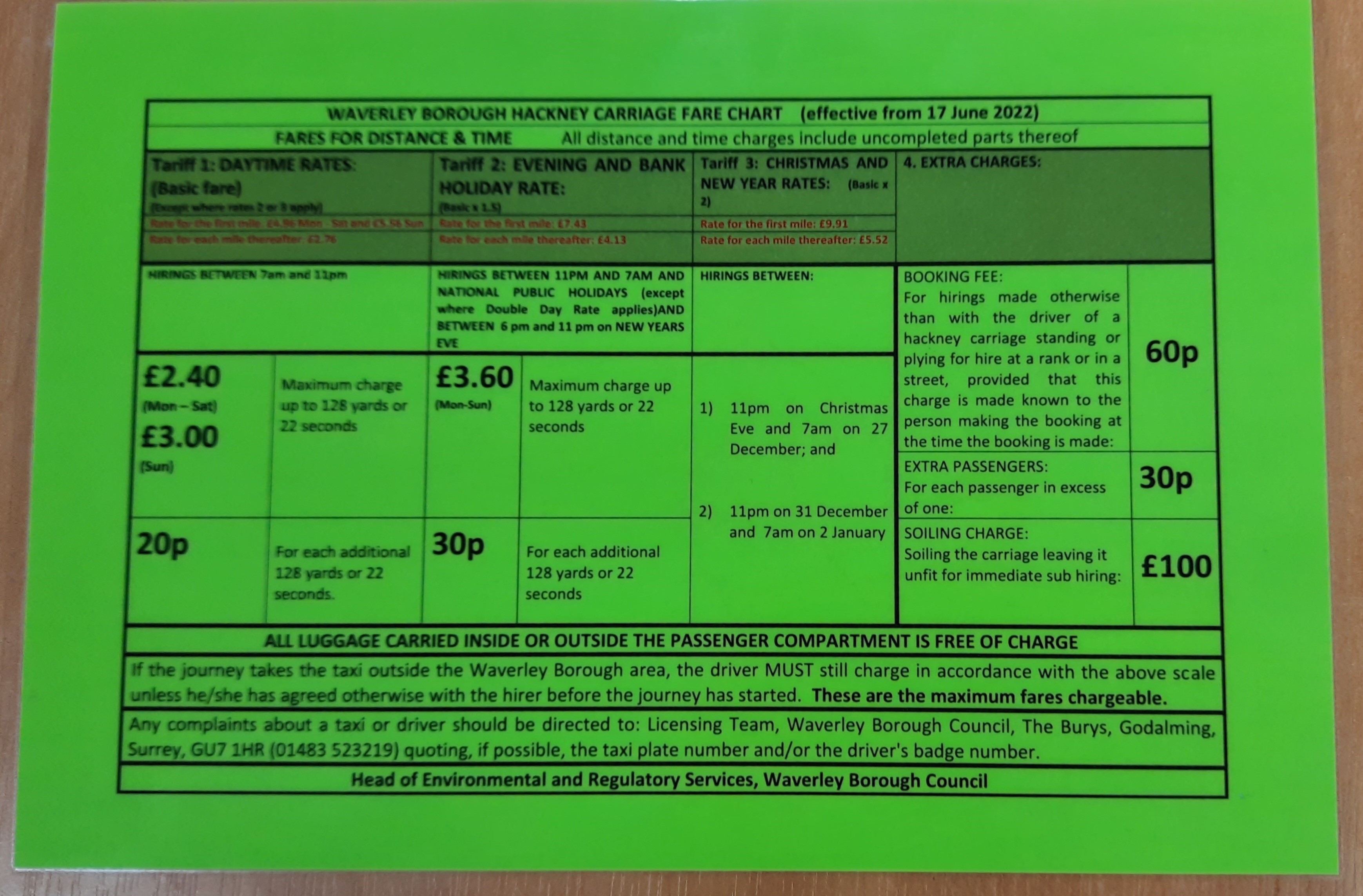 Image of the taxi fare chart printed on lime green card, by way of example